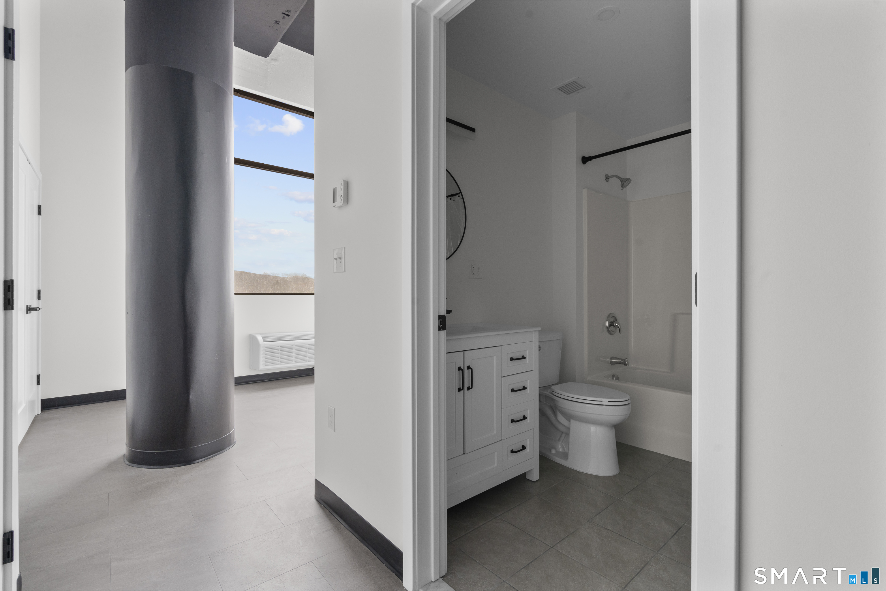 480 Myrtle Street, Unit 404 New Britain, CT 06053 - Photo 4 of 18 a bathroom with a toilet sink and a mirror