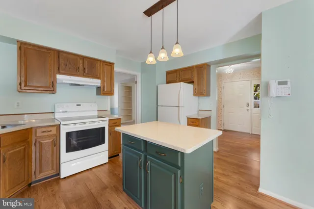 a kitchen with a stove a refrigerator and a sink