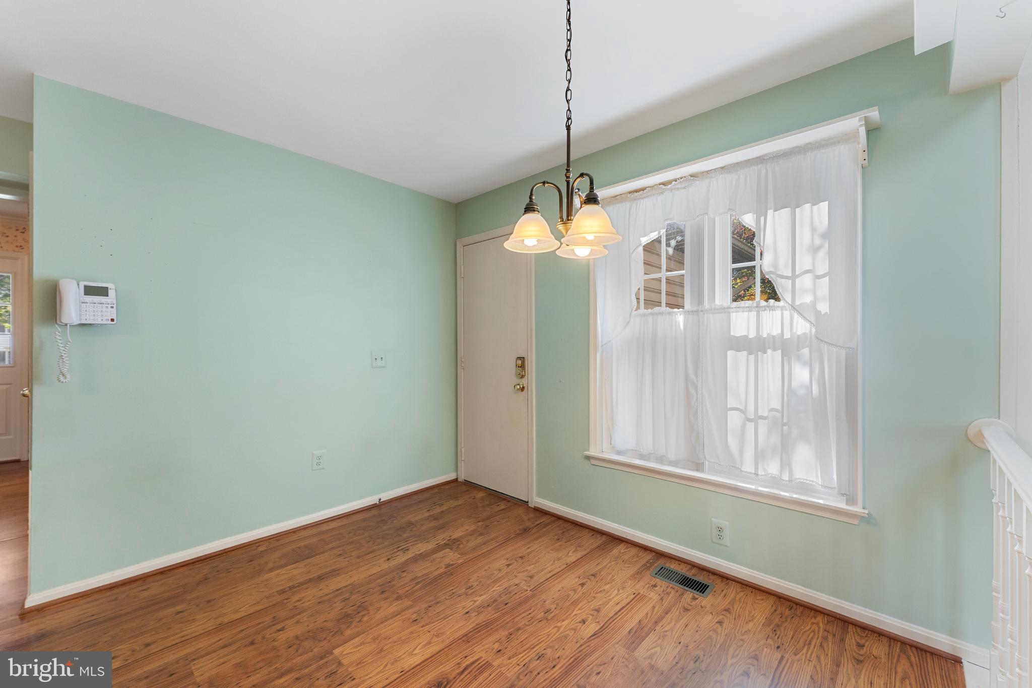 9304 Bellbeck Road Baltimore, MD 21234 - Photo 16 of 37 a view of an empty room with window and chandelier fan