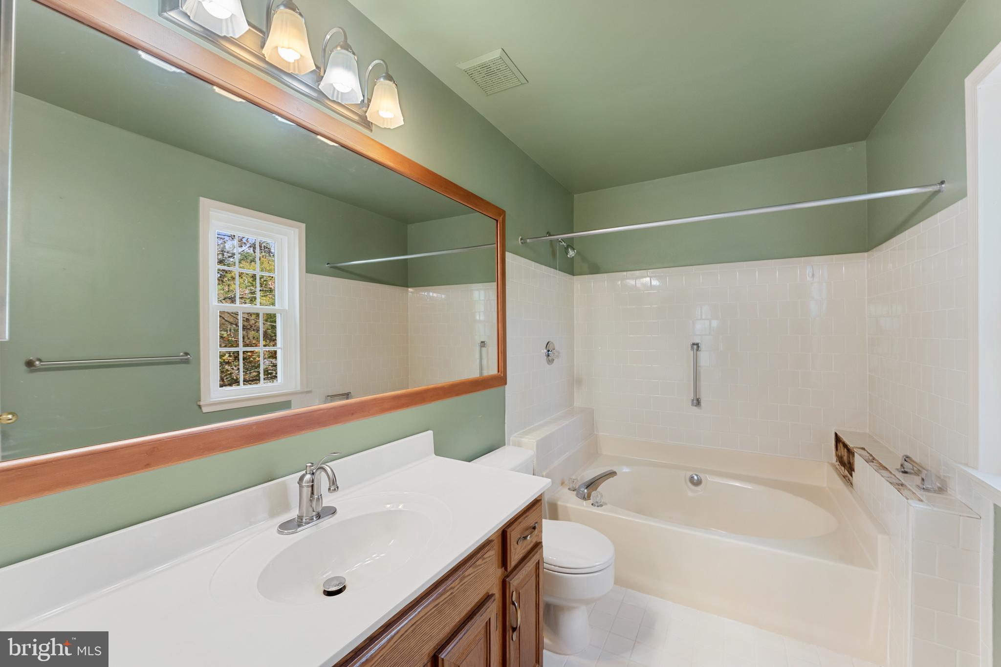 9304 Bellbeck Road Baltimore, MD 21234 - Photo 23 of 37 a bathroom with a bathtub shower sink vanity and toilet