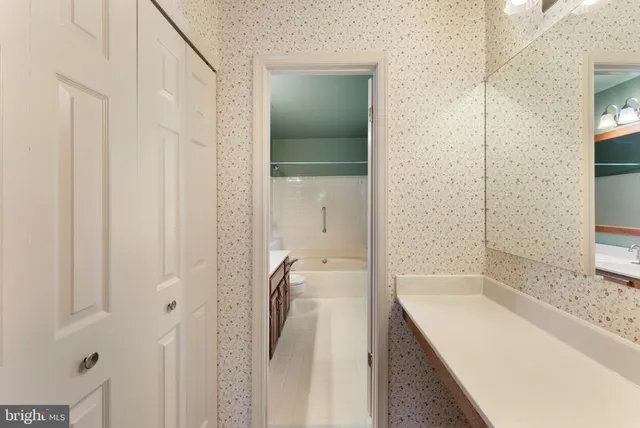 a bathroom with a granite countertop sink a toilet and shower
