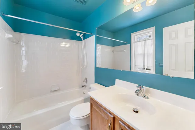 a bathroom with a sink mirror toilet and bathtub