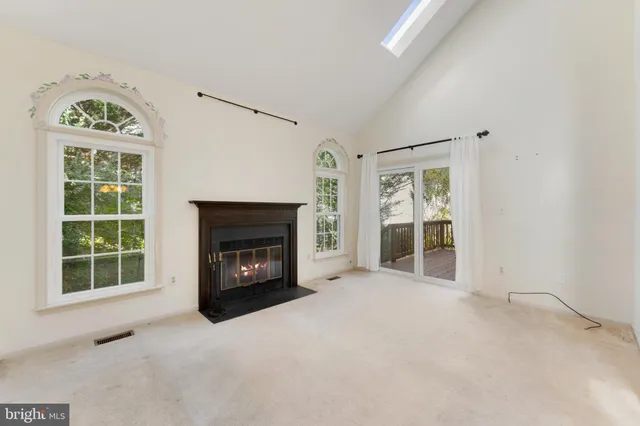 an empty room with furniture and a fireplace