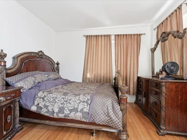 a bedroom with a bed and a dresser