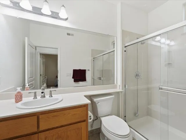 a bathroom with a sink toilet a mirror and shower