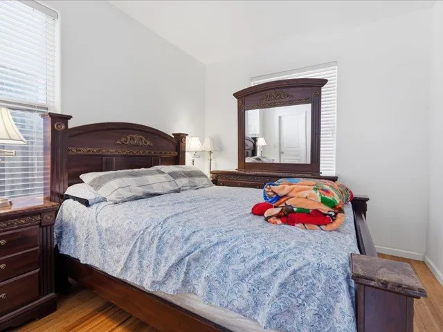 a bedroom with a bed and a painting on the wall