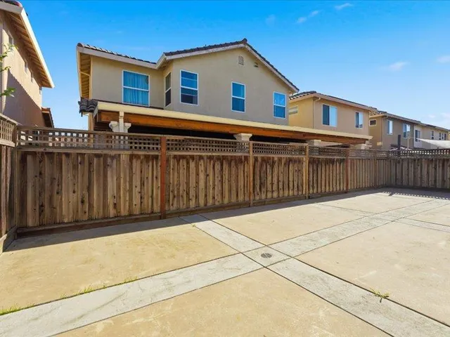 a view of a house with wooden fence