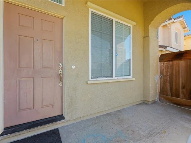 a view of an empty room with closet and mirror