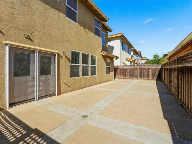 a view of a house with wooden floor and a fence