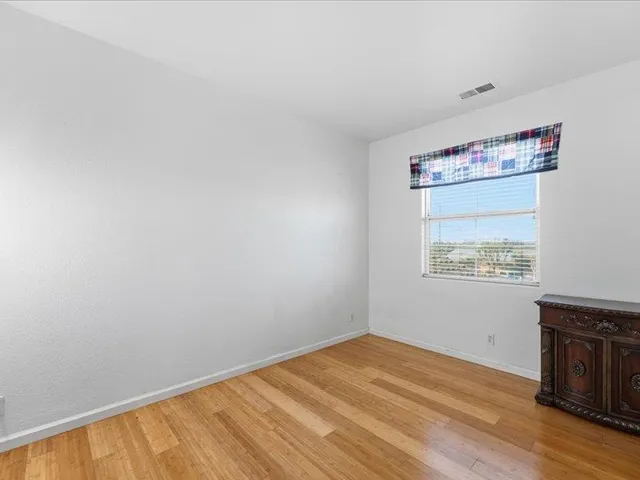 a view of an empty room and wooden floor
