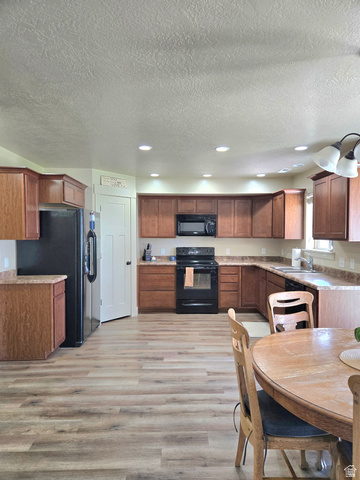 601 West 150 North, Unit 25 Springville, UT 84663 - Photo 5 of 29 Kitchen featuring wood-finish flooring, recessed lighting, and a full suite of black appliances