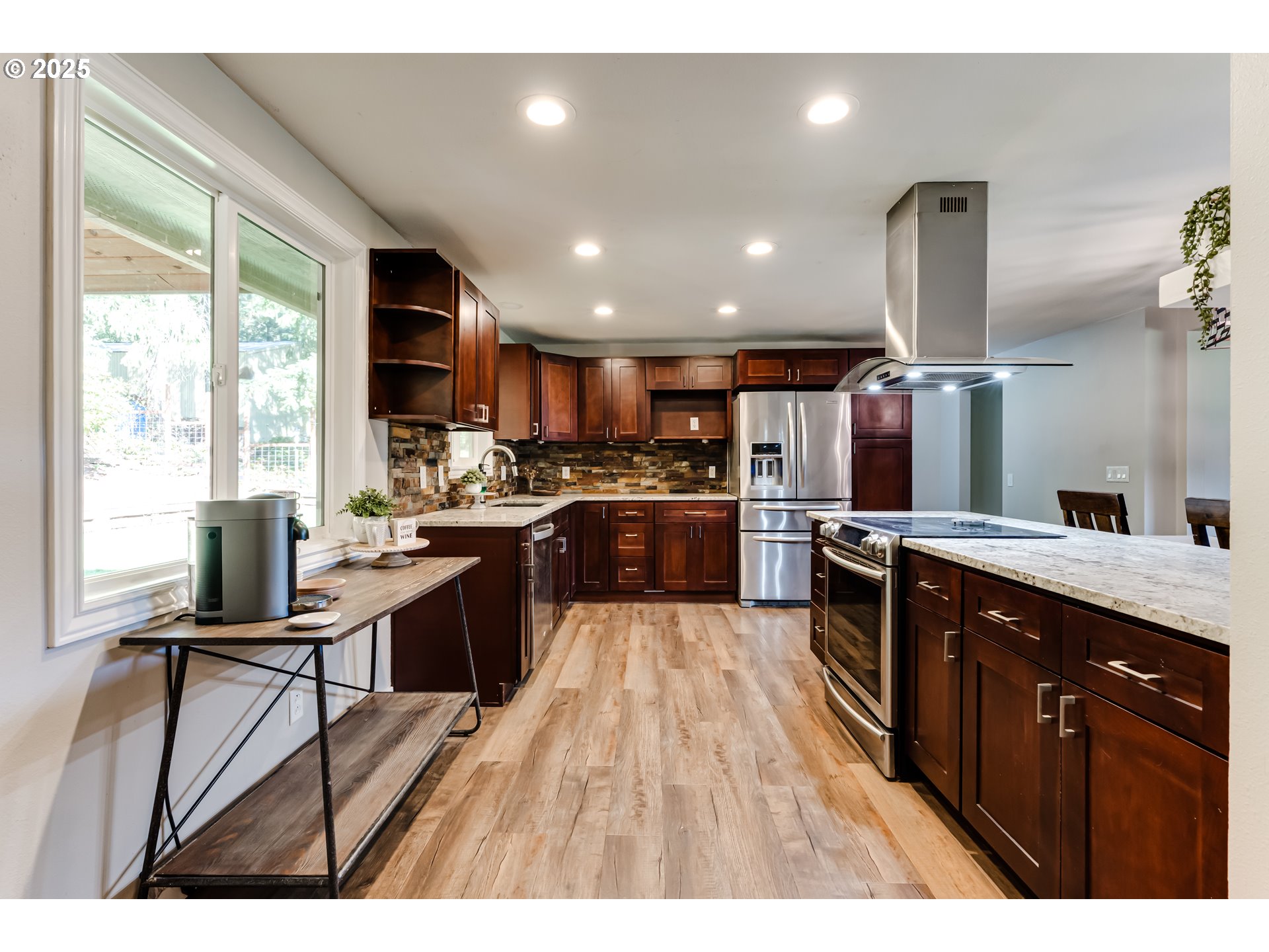 24531 Vaughn Road Veneta, OR 97487 - Photo 12 of 47 a kitchen with stainless steel appliances granite countertop wooden cabinets a sink dishwasher and a stove with wooden floor