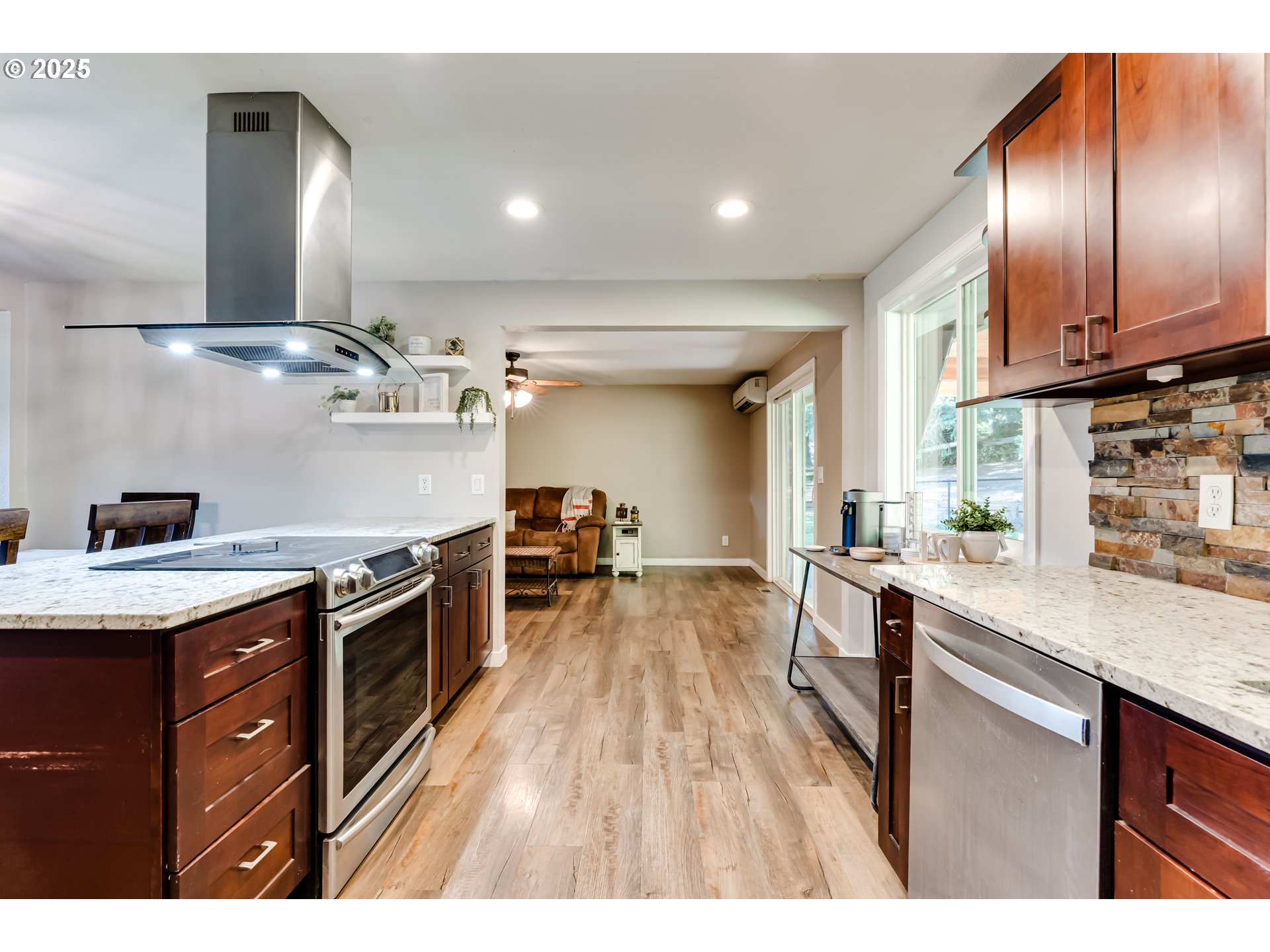 24531 Vaughn Road Veneta, OR 97487 - Photo 14 of 47 a kitchen with granite countertop a stove a sink and a wooden floors