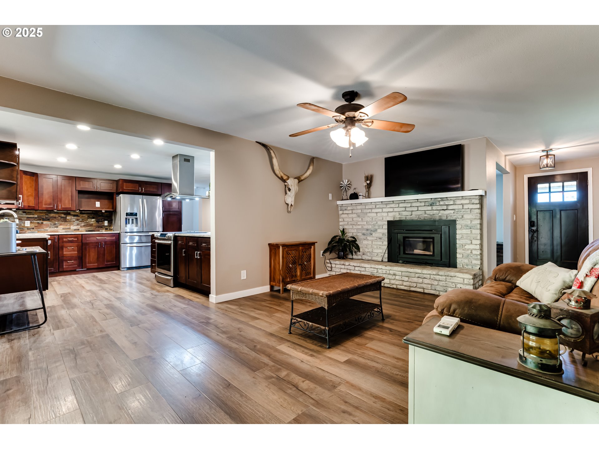 24531 Vaughn Road Veneta, OR 97487 - Photo 15 of 47 a living room with furniture fireplace and a flat screen tv