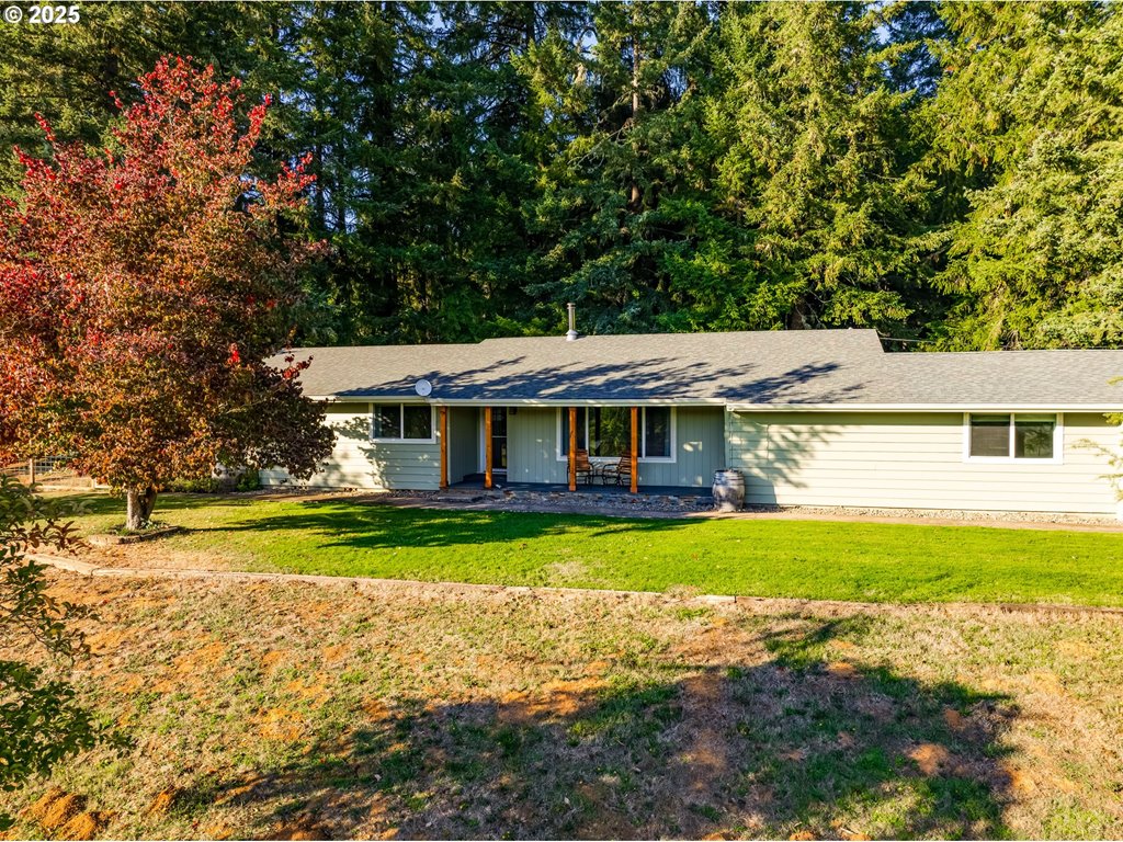 24531 Vaughn Road Veneta, OR 97487 - Photo 2 of 47 a front view of a house with a yard table and chairs