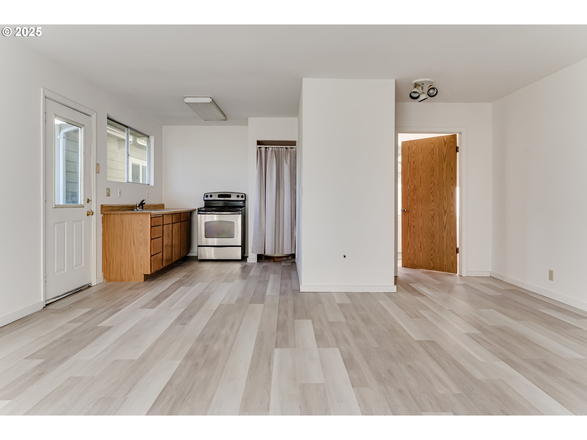 24531 Vaughn Road Veneta, OR 97487 - Photo 38 of 47 a view of a kitchen with a stove wooden floor cabinet and a refrigerator