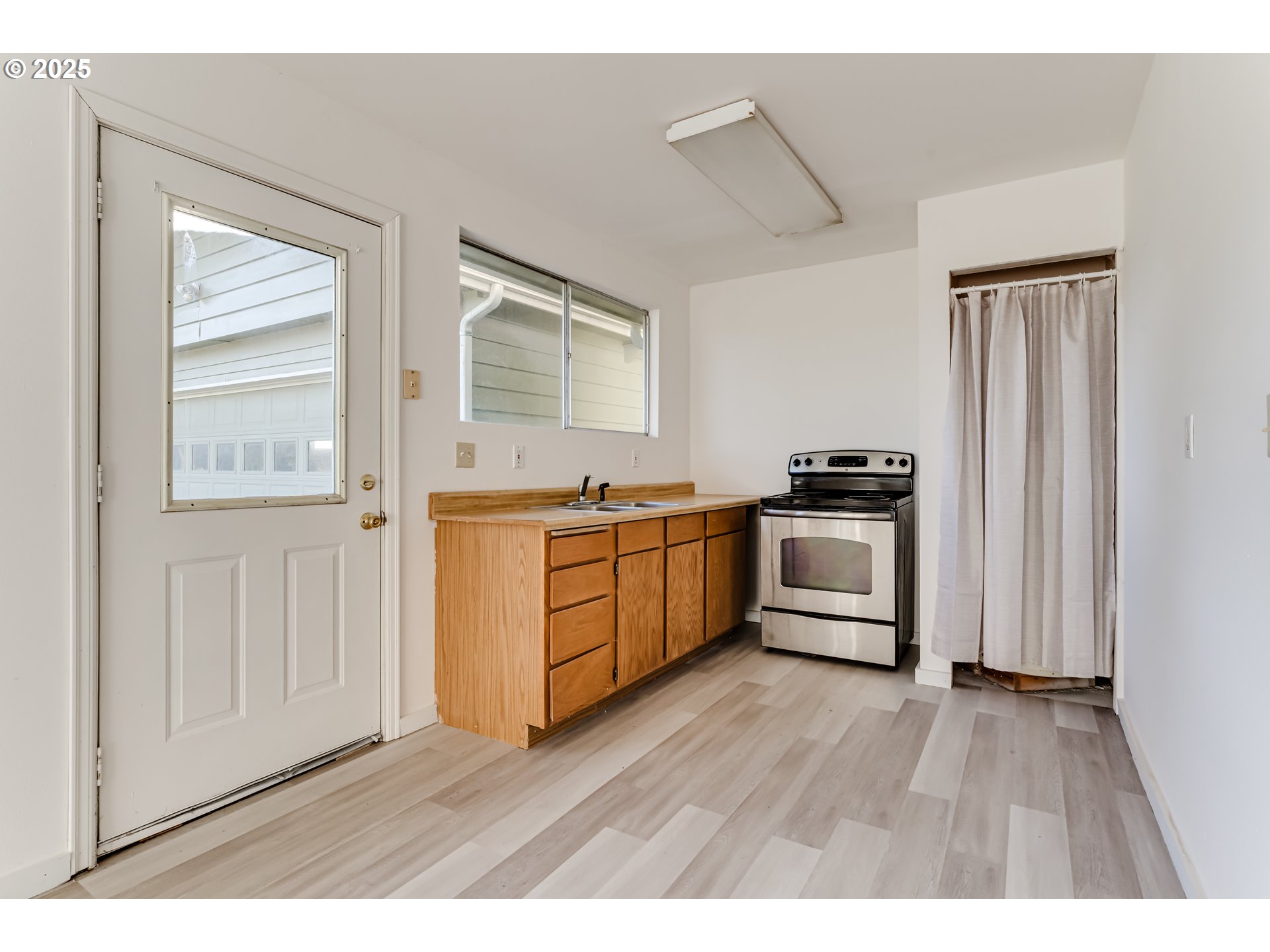 24531 Vaughn Road Veneta, OR 97487 - Photo 39 of 47 a kitchen with stainless steel appliances a white cabinets and wooden floor