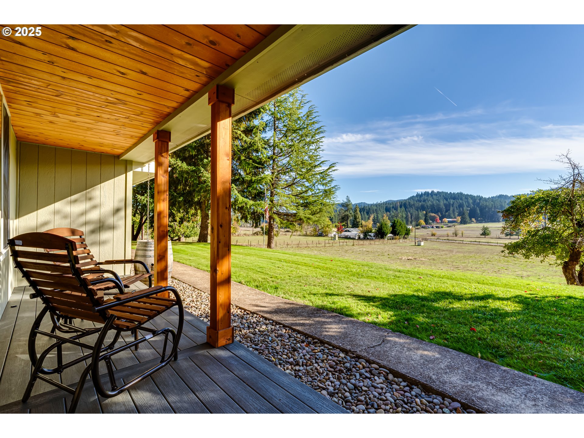 24531 Vaughn Road Veneta, OR 97487 - Photo 6 of 47 a view of a patio with table and chairs with plants and wooden fence