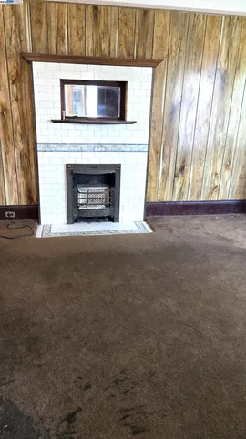 a view of empty room with a fireplace