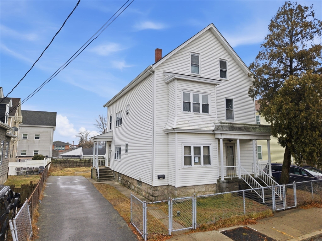 a view of a house with wooden fence