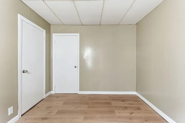 a view of an empty room with wooden floor