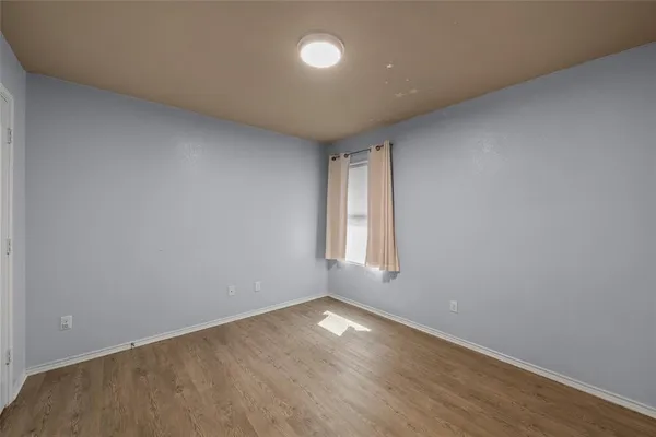an empty room with a empty space and a window