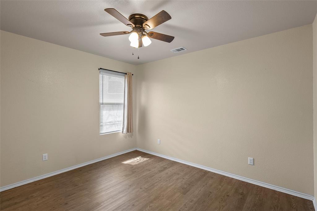 10321 Walley Way Waco, TX 76708 - Photo 15 of 19 an empty room with a window and a fan