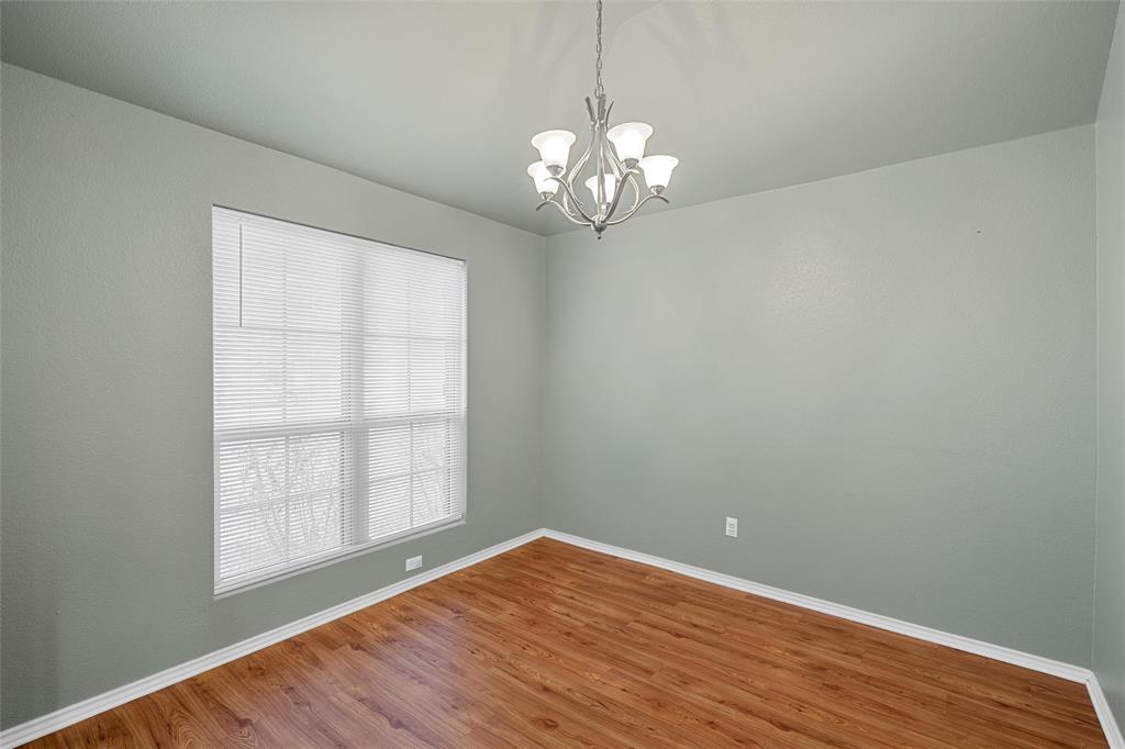 10321 Walley Way Waco, TX 76708 - Photo 2 of 19 wooden floor in an empty room with a window