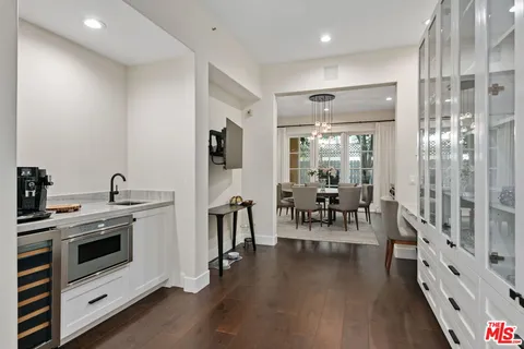 a kitchen with stove and white cabinets