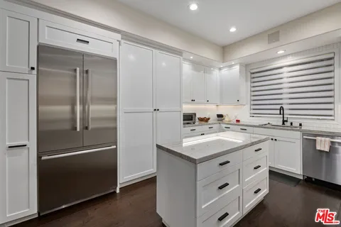 a kitchen with a sink and a refrigerator