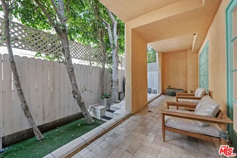 a building outdoor space with patio furniture and potted plants