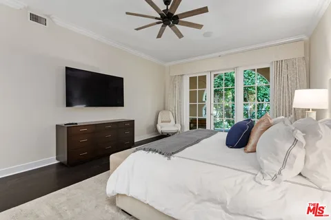 a spacious bedroom with a bed and a lamp