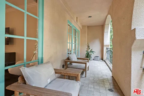 a view of balcony with furniture