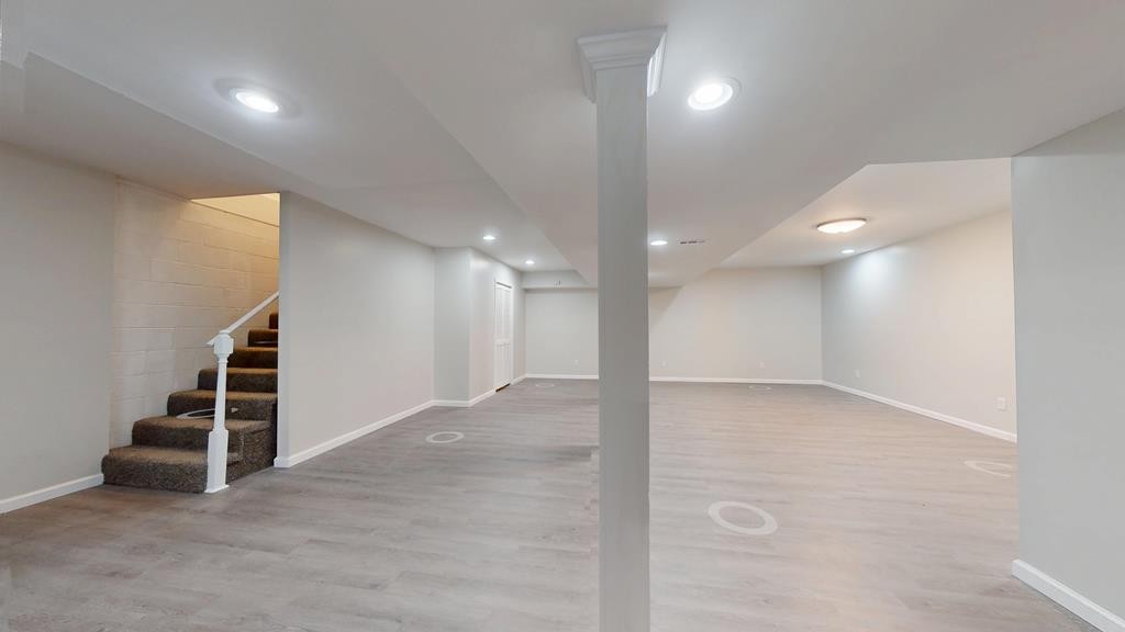 3766 Old Bridge Road Cookeville, TN 38506 - Photo 38 of 88 an empty room with wooden floor and stairs