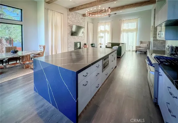 a view of dining room with wooden floor and chandelier