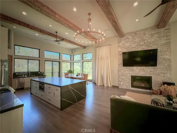 a living room with fireplace furniture and a wooden floor