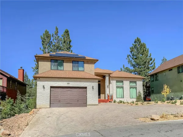 a front view of a house with a yard and a garage
