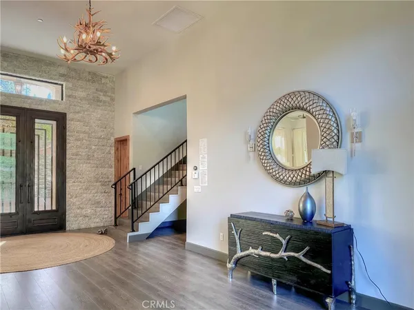 a living room with furniture and a mirror