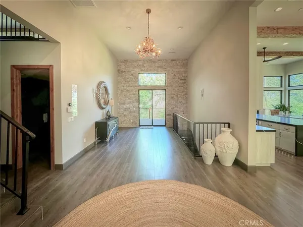 a view of a room with wooden floor and windows