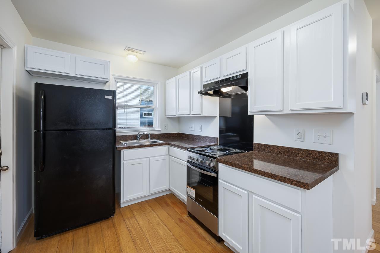 914 South Person Street Raleigh, NC 27601 - Photo 8 of 19 a kitchen with a refrigerator stove and cabinets