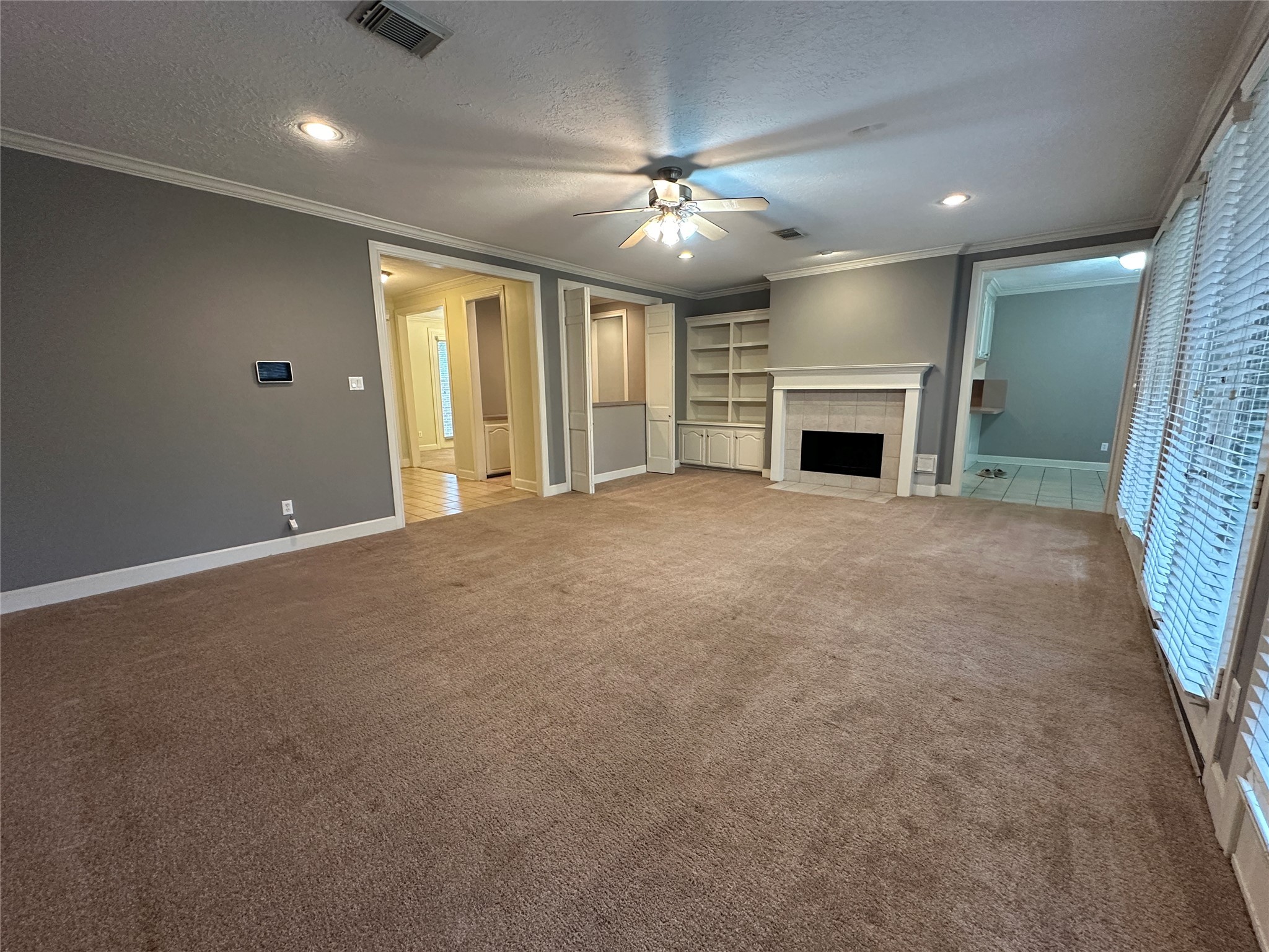 7710 Post Bridge Road Spring, TX 77389 - Photo 12 of 38 a view of an empty room with a fireplace and a chandelier fan