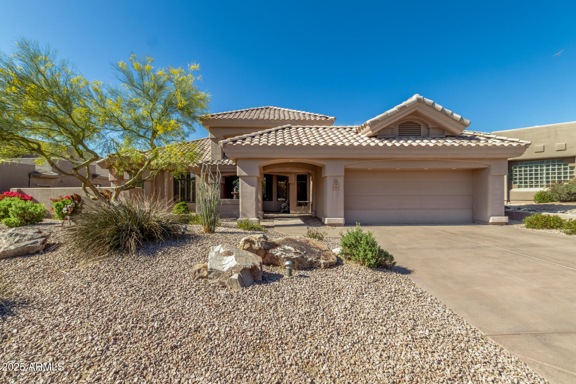 6645 East Redmont Drive, Unit 13 Mesa, AZ 85215 - Photo 1 of 41 a front view of a house with garden