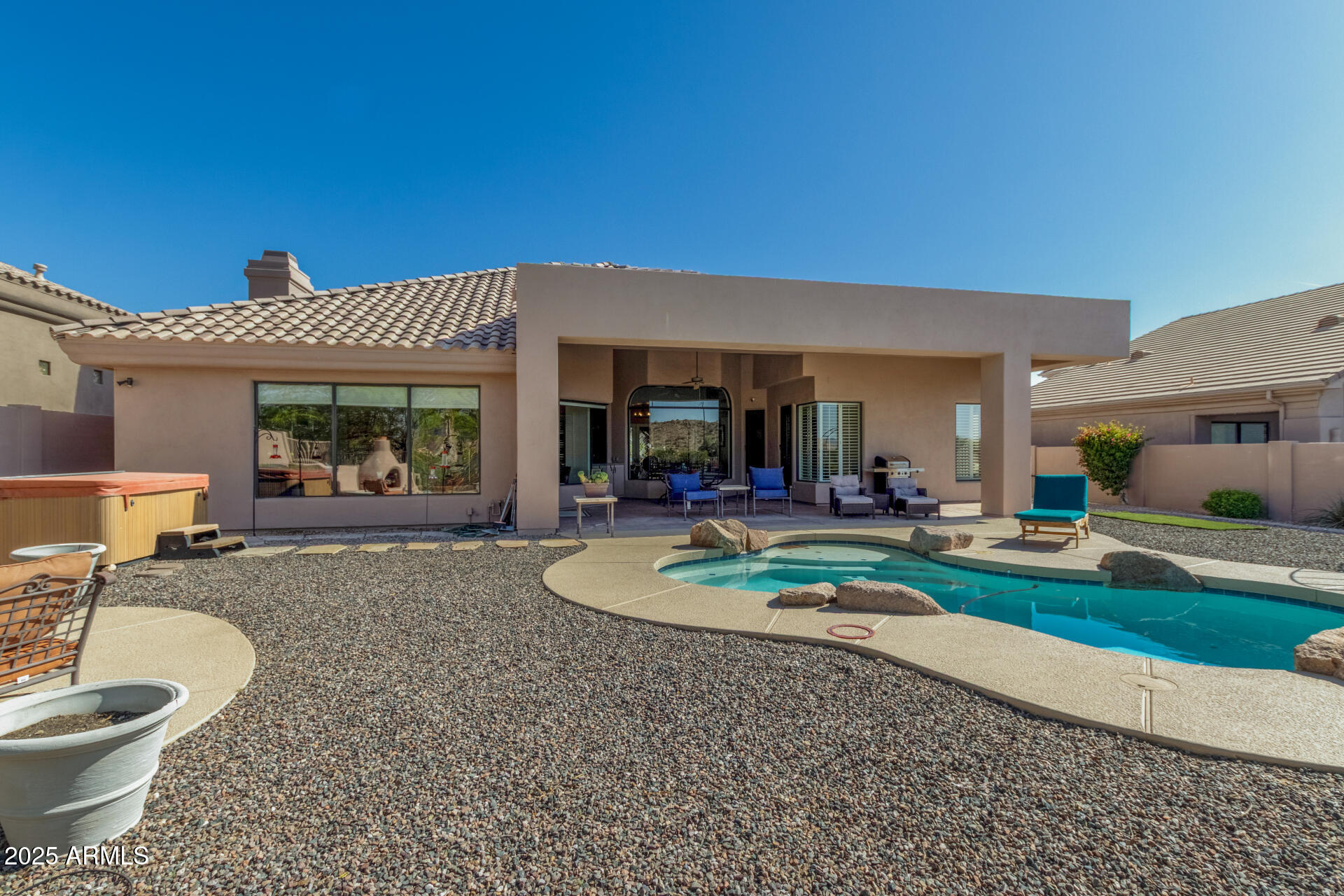 6645 East Redmont Drive, Unit 13 Mesa, AZ 85215 - Photo 29 of 41 a view of a house with backyard porch and patio
