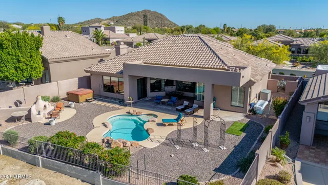 an aerial view of a house with outdoor seating