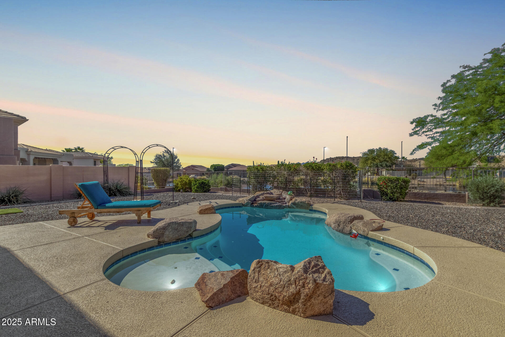 6645 East Redmont Drive, Unit 13 Mesa, AZ 85215 - Photo 40 of 41 a view of a swimming pool with a yard and sitting area
