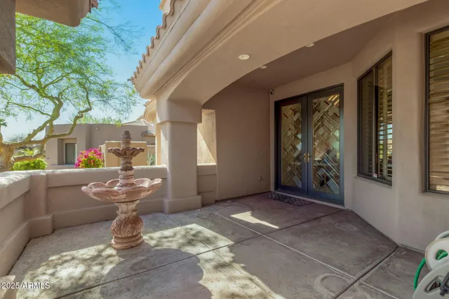 a living room with a couch and a potted plant