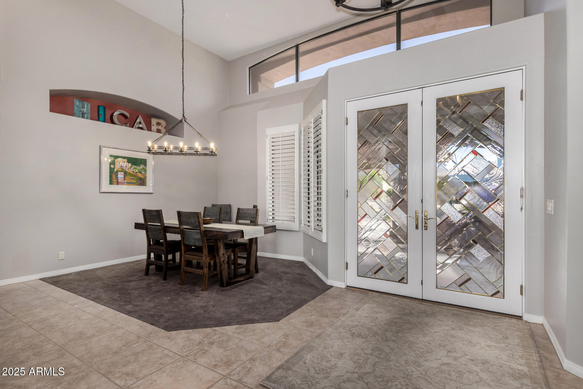 6645 East Redmont Drive, Unit 13 Mesa, AZ 85215 - Photo 5 of 41 a view of a dining room with furniture and chandelier