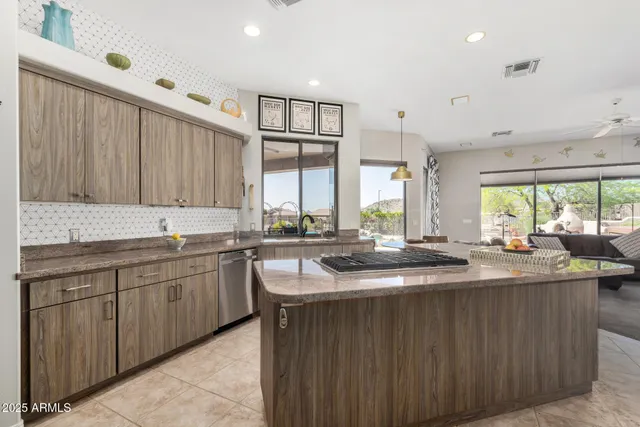 a kitchen with lots of counter space and windows