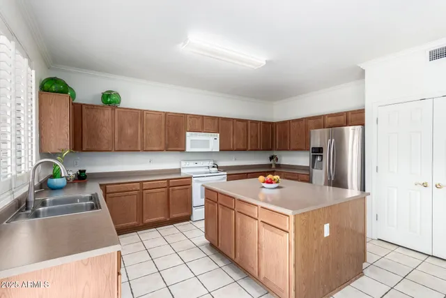 a kitchen with stainless steel appliances a stove a sink dishwasher and white cabinets