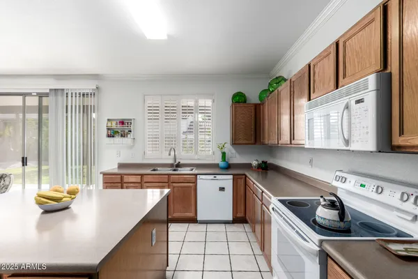 a kitchen with a sink a stove and cabinets